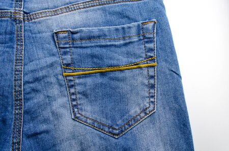 close up view of back pocket vintage blue denim jeans pant fashion, texture background isolated on white background, selective focusの写真素材