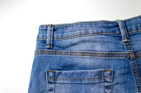 close up view of back pocket vintage blue denim jeans pant fashion, texture background isolated on white background, selective focusの写真素材