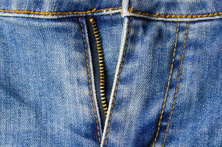 close up detail zipper of vintage blue denim jeans pant fashion, texture background, selective focusの写真素材