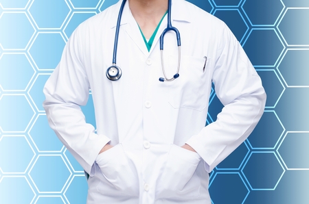 smart doctor with a stethoscope around his neck with abstract hexagon pattern design in blue and white color tone background, health care and medical technology conceptの写真素材