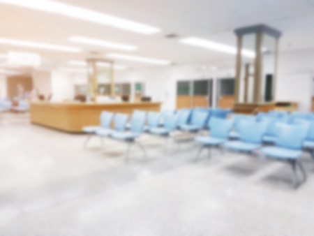 abstract blurred image of empty chairs in waiting room at hospital, sunlight effectの写真素材