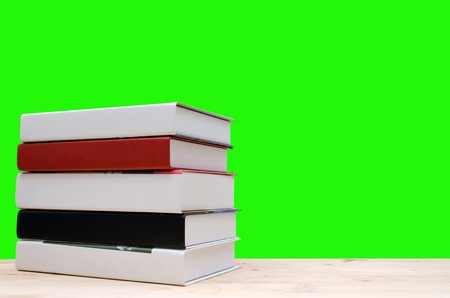 stack book on desk, no labels, blank spine with green background, education back to school and business concept, copy spaceの写真素材