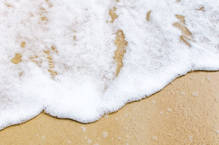 top view of soft sea wave on sand at the beach, beach background and summer concept, sunlight effect, copy spaceの写真素材