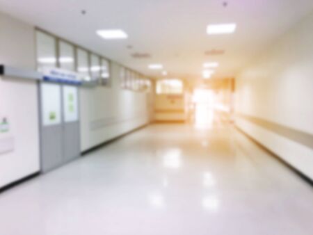 abstract blurred image of hospital or clinic interior for background with sunlight effect, light of life and emergency save life conceptの写真素材