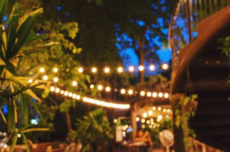 abstract urban night light bokeh of night festival in garden, light blurred background, vintage color tone, festival holiday light background conceptの写真素材