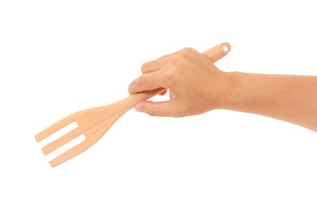hand holding wooden fork isolated on white backgroundの写真素材