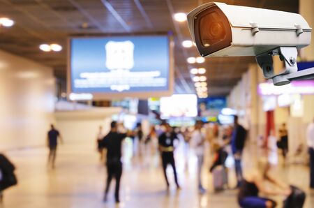 CCTV, security camera system operating record and property protection with blurred image of passenger in airport terminal, surveillance security technology and transportation conceptの写真素材