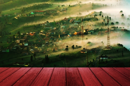 empty wooden desk, terrace or floor copy space for display of product or object presentation with image of sunrise at Cemoro lawang village at Bromo mount at Indonesia, landscape nature conceptの写真素材