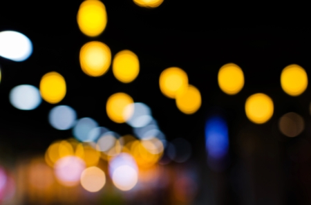 abstract night light bokeh on dark background, colorful circles background for christmas or new year festivalの写真素材