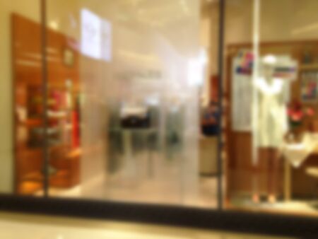 blurred image of showcases fashion clothes display in department store shopping mall, shopping lifestyle conceptの写真素材