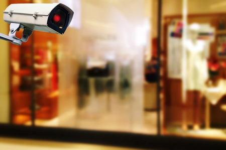 CCTV, security indoor camera system operating with blurred image of showcases fashion brand name...