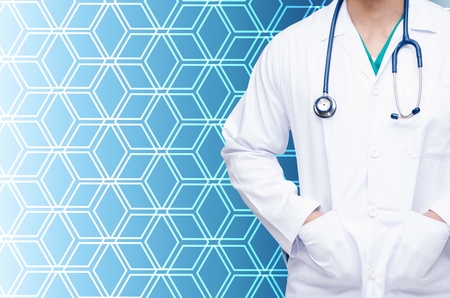 smart doctor with stethoscope standing with blue hexagon shape pattern background, heart health care, medical diagnosis and medical technology conceptの写真素材
