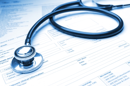 close up stethoscope and medical information form on desk, healthcare technology, medical research diagnosis, medical report record and history patient concept, selective focus, blue color toneの写真素材