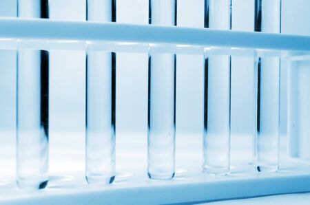 bottom view of row of liquid in laboratory test tube, science, chemical and medical research concept, blue color tone, soft and selective focusの写真素材