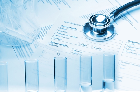 double exposure of stethoscope, test tube, beaker and patient information form on desk, healthcare, medical research diagnosis, medical report record and history patient concept, blue color toneの写真素材