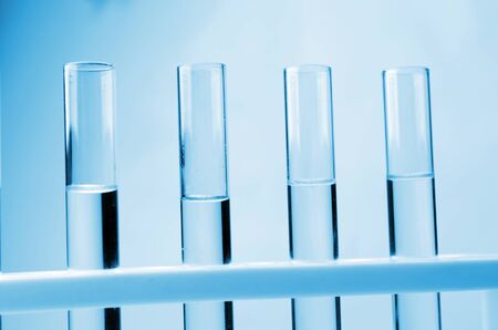 row of liquid in laboratory test tube, science, chemical and medical research concept, blue color tone, soft and selective focusの写真素材