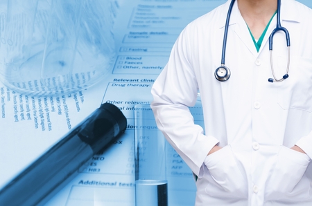 smart doctor with a stethoscope with double exposure of test tube, beaker and medical information form on desk, medical research diagnosis, blood test and medical report record concept, blue toneの写真素材