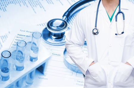 smart doctor with a stethoscope with double exposure of stethoscope, laboratory test tube and medical information form on desk, science, chemical, healthcare and medical research concept, blue toneの写真素材