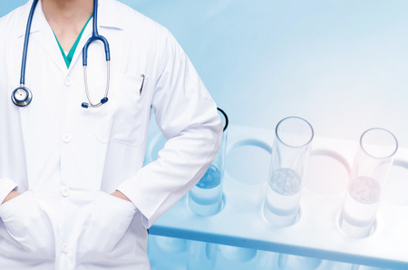 smart doctor with a stethoscope and close up chemical liquid in laboratory test tube with light effect background, people, laboratory, science, chemical and medical research conceptの写真素材
