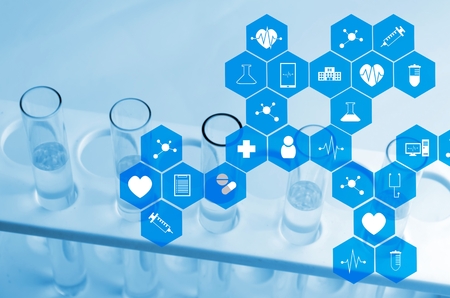 close up chemical liquid in laboratory test tube with medical icon in hexagon pattern, blue color tone, laboratory, science, chemical and medical research concept, soft and selective focusの写真素材