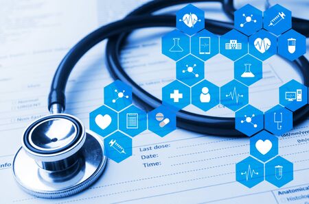 stethoscope and medical information form on desk with medical icon in hexagon pattern, blue color tone, laboratory, science, chemical and medical research conceptstethoscope and medical information form on desk with medical icon in hexagon pattern, blue cの写真素材