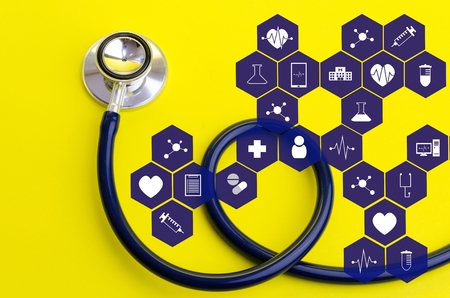 stethoscope on yellow background with medical icon in hexagon pattern, heart health care, laboratory, science, chemical and medical research conceptの写真素材
