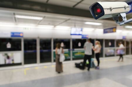 CCTV security indoor camera system operating with blurred image of people waiting for subway at train station, transportation, surveillance security, safety technology conceptの写真素材