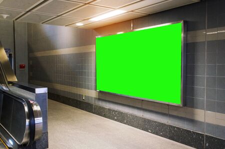 blank green advertising billboard with copy space for your text message or media and content in subway train station or airport, information board, mock up banner, marketing and advertising conceptの写真素材