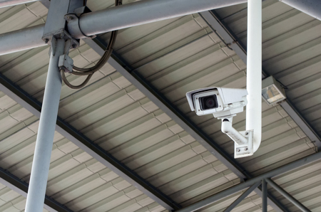 CCTV, security camera system operating under roof, surveillance security and safety technology...