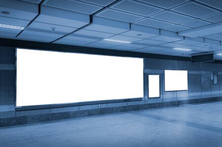 blank advertising billboard or light box with copy space for your text message or media content in subway train station or airport, information board, commercial, marketing concept, blue tone colorの写真素材