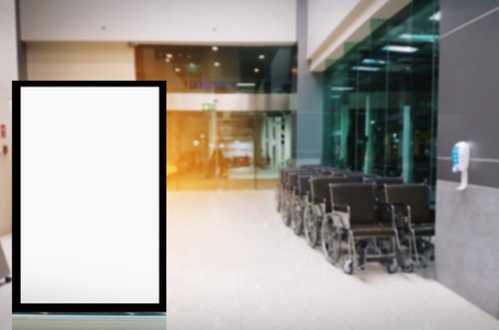 mock up of blank showcase billboard or advertising light box for your text message or media content with empty wheelchair for patient in hospital, commercial, marketing and advertising conceptの写真素材