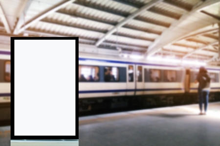 mock up of blank showcase billboard or advertising light box for your text message or media content with people waiting sky train at train station, commercial, marketing and advertising conceptの写真素材