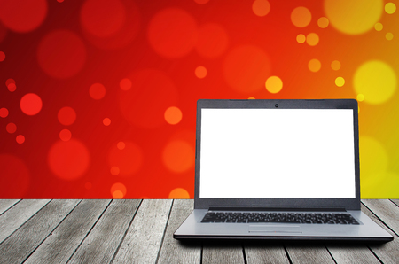 laptop computer with blank screen for presentation on wooden desk and colorful light bokeh background, advertising, commercial, marketing, technology, internet and business conceptの写真素材