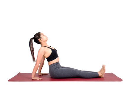 young asian woman doing yoga in Purvottanasana or Upward Plank yoga pose on the mat isolated on...