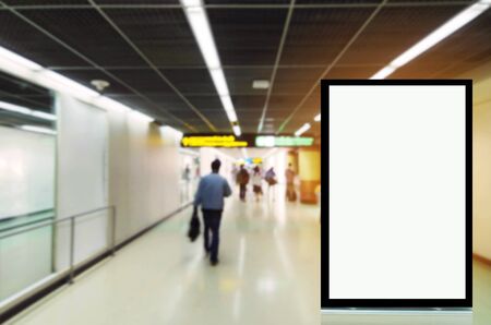 mock up of vertical advertising billboard or blank showcase light box for your text message or media content with people walking at the airport, commercial, marketing and advertisement conceptの写真素材