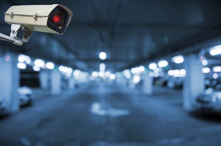 CCTV, security indoor camera system operating in underground car parking garage area, blue color tone, surveillance security and safety technology conceptの写真素材