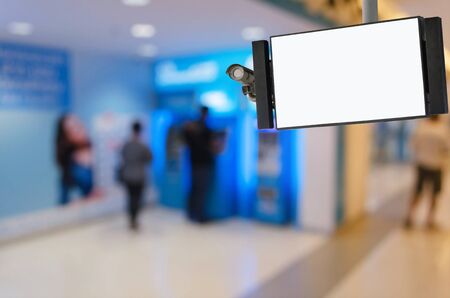 CCTV and LCD TV with white blank screen or billboard with blurred image of people queuing to...