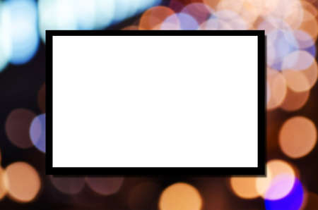 blank advertising billboard or wide screen television on night light bokeh background, copy space for display of product presentation, commercial and marketing conceptの写真素材