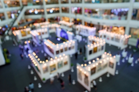 top view blurred image of event hall at shopping mall or public event exhibition hall, big sale promotion, black friday, business trade show concept, vintage color toneの写真素材