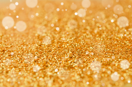 defocused golden shiny and glitter wallpaper for holidays, christmas, new year and valentine festival background, abstract bokeh light background, copy space, high contrast color toneの写真素材