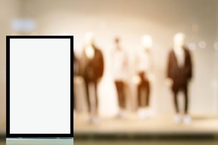 vertical light box or advertising billboard in front of men fashion clothes shop showcase in...