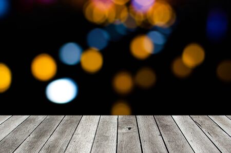 wooden terrace or desk with copy space for display of product or object presentation with bokeh light in the city at nightの写真素材
