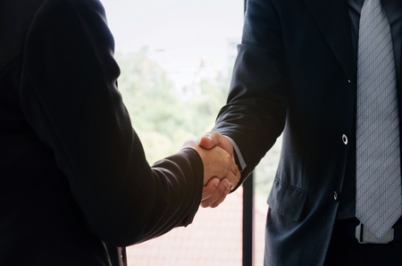 business man handshake after finishing up a business meeting in office, congratulation, success, meeting, partner, teamwork, community, connection concept, vintage tone, selective focusの写真素材