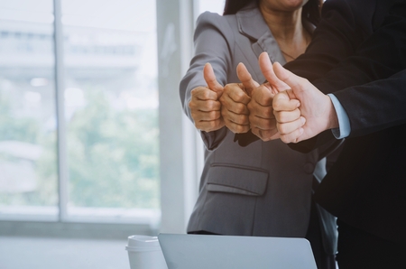 group of business people team showing thumbs up as like sign together in office, successful, support, meeting, partner, teamwork, community, connection concept, vintage color tone, selective focusの写真素材