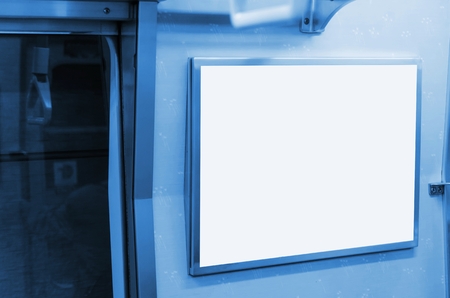 blue color tone image of blank advertising billboard or light box showcase on wall inside subway train at station, copy space for your text message or media content, commercial and marketing conceptの写真素材