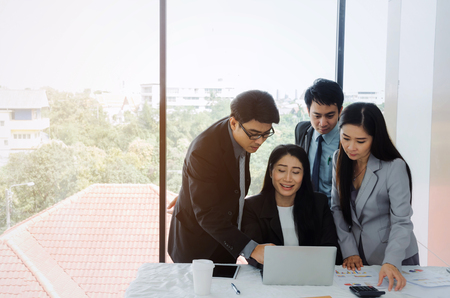 group of asian business people team success planning work together with laptop computer on desk in meeting room at office, support, partner, teamwork, community, connection and startup project conceptの写真素材
