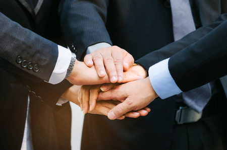 close up group of big business people team joining hands together in the modern city, team leader, successful, support, meeting, partner, teamwork, community and connection concept, selective focusの写真素材