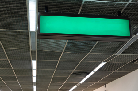 hanging blank advertising billboard or light box showcase on wall at airport or subway train station, copy space for your text message or media content, advertisement, commercial and marketing conceptの写真素材
