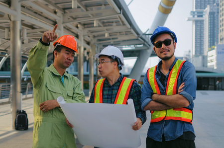 group of engineer, technician and architect planning about new project building plan with blueprint in modern city building background, contractor, construction site, business and industry conceptの写真素材