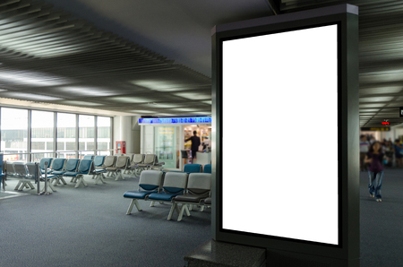 mock up of vertical blank advertising billboard or light box showcase with people waiting at airport, copy space for your text message or media content, advertisement, commercial and marketing conceptの写真素材